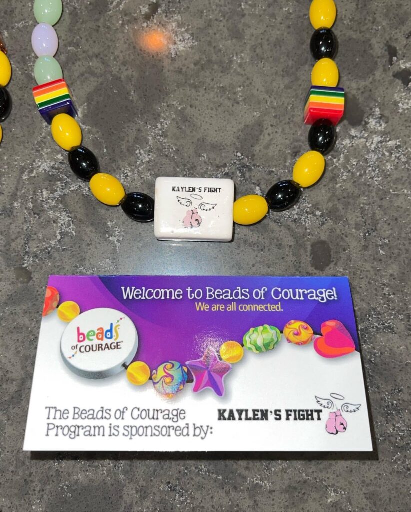 Photo of Beads of Courage and Kaylen's Fight Logo Bead for sponoring the program