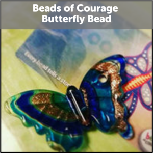 Beads of Courage Butterfly Bead. A glass bead in a butterfly shape. Colored royal blue with gold swirls