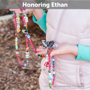 Ethan's sister holding a strand of his beads of Courage collection and the Butterfly bead for bereavement honoring Ethan