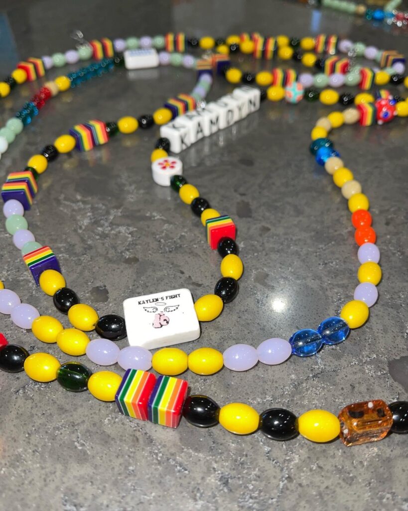 Photo of Kamdyn's Beads of Courage and Kaylen's Fight Logo Bead for sponoring the program